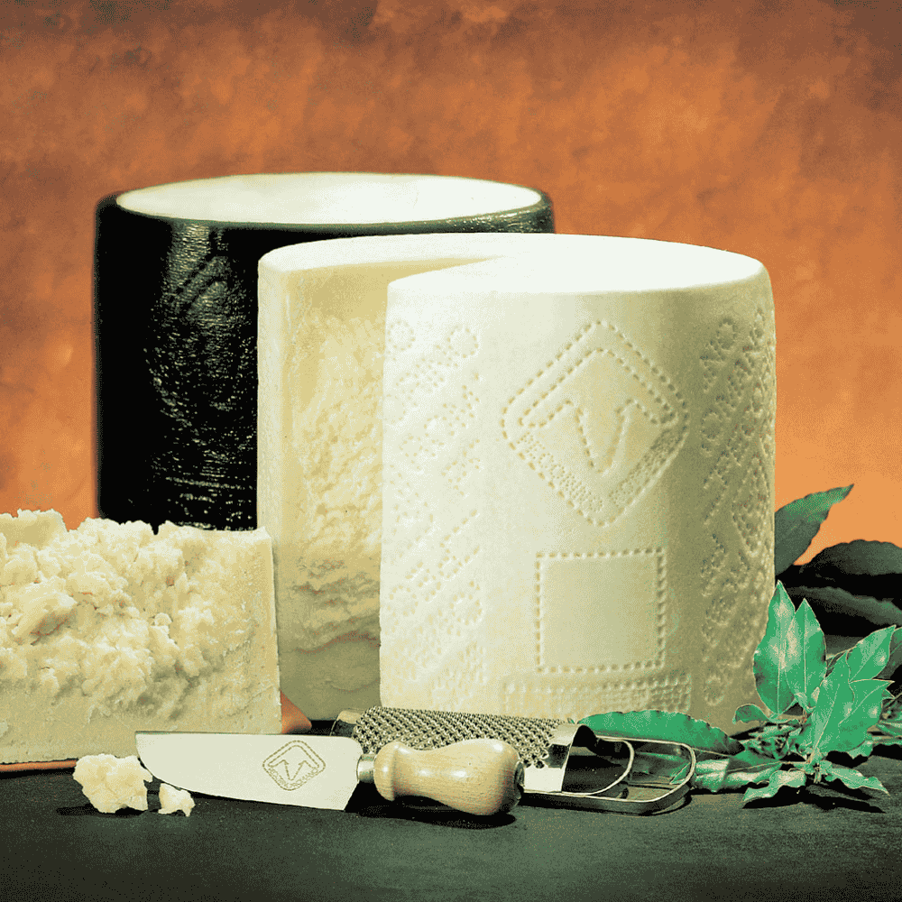 pecorino romano cheese with a knife on a textured surface