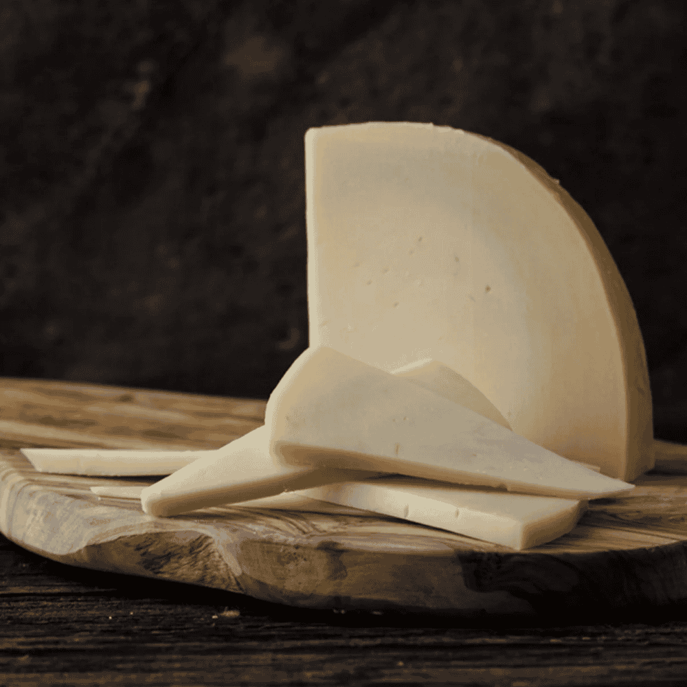 sliced provolone piccante on dark backgorund